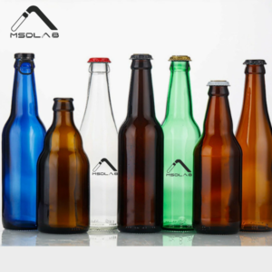 A row of 500ml glass beer bottles in blue, amber, clear, and green colors with crown caps.